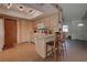 Kitchen with breakfast bar, wood cabinets, and white appliances at 1860 Bluebird Ln, Englewood, FL 34224