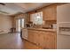 Kitchen offers wood cabinets, white appliances, and backyard access at 1860 Bluebird Ln, Englewood, FL 34224