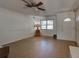 Living room with tile floor, ceiling fan, and window at 1860 Bluebird Ln, Englewood, FL 34224