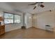 Living room with tile floor, ceiling fan, and window at 1860 Bluebird Ln, Englewood, FL 34224
