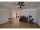 Living room with tile floor, piano, and ceiling fan at 1860 Bluebird Ln, Englewood, FL 34224