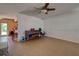 Living room with tile floor, piano, and view into kitchen at 1860 Bluebird Ln, Englewood, FL 34224