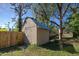 Tan wooden storage shed with metal roof at 1860 Bluebird Ln, Englewood, FL 34224