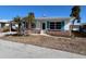 Single-story home with teal shutters and a brick facade at 1977 Beach Rd # 55, Englewood, FL 34223