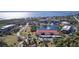 Aerial view of community with lake, pool, and tennis courts at 23465 Harborview Rd # 203, Punta Gorda, FL 33980