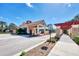 Community clubhouse entrance featuring red tile roof, covered entry, sidewalks and landscaping at 23798 Waverly Cir, Venice, FL 34293