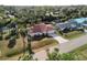 Single-story home with red tile roof, situated on a canal in a lush residential area at 2397 Cannolot Blvd, Port Charlotte, FL 33948