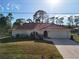 Single-story home with red tile roof and a two-car garage at 2397 Cannolot Blvd, Port Charlotte, FL 33948