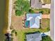 Aerial view of the property showcasing the pool, metal roof, and manicured landscaping near the water at 26098 Constantine Rd, Punta Gorda, FL 33983