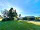 Expansive backyard with lush lawn and screened-in pool on a waterfront property at 26098 Constantine Rd, Punta Gorda, FL 33983