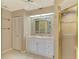 Bright bathroom boasts white cabinets, granite countertop, and a glass shower door at 26098 Constantine Rd, Punta Gorda, FL 33983
