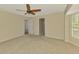 The bedroom offers neutral carpet, ceiling fan, shutters and two entryways at 26098 Constantine Rd, Punta Gorda, FL 33983