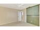 Bedroom with a green feature wall, a ceiling fan, and a door to the hallway at 26098 Constantine Rd, Punta Gorda, FL 33983