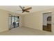 The bedroom features a ceiling fan, a sliding glass door and natural lighting at 26098 Constantine Rd, Punta Gorda, FL 33983