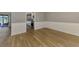 Open-concept dining room with wood-look floors, wainscoting, and easy access to the updated kitchen at 26098 Constantine Rd, Punta Gorda, FL 33983