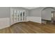 Dining room with wainscoting, wood-look floors and large windows offering ample natural light at 26098 Constantine Rd, Punta Gorda, FL 33983
