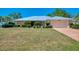 Beautiful single-story home with a metal roof, stone accents and well-manicured landscaping at 26098 Constantine Rd, Punta Gorda, FL 33983