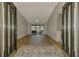 Inviting foyer with wood floors, decorative rug, and views of the living room and waterfront beyond at 26098 Constantine Rd, Punta Gorda, FL 33983