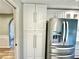 White kitchen cabinets and stainless steel refrigerator at 26098 Constantine Rd, Punta Gorda, FL 33983