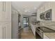 Bright, modern kitchen features white cabinetry, stainless steel appliances, and granite countertops at 26098 Constantine Rd, Punta Gorda, FL 33983