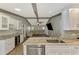 Modern kitchen features granite countertops, stainless steel appliances, and a wine cooler at 26098 Constantine Rd, Punta Gorda, FL 33983