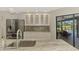 Kitchen featuring granite countertops, stainless steel appliances, a breakfast bar, and lanai access at 26098 Constantine Rd, Punta Gorda, FL 33983