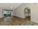 Bright living room with wood-look floors, neutral walls, and a view of the lanai and waterfront at 26098 Constantine Rd, Punta Gorda, FL 33983