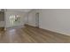 Open-concept living area with wood floors, leading to other rooms and featuring a coat closet at 26098 Constantine Rd, Punta Gorda, FL 33983