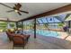 Screened-in outdoor patio with a pool, hot tub, seating area, and lake view at 26098 Constantine Rd, Punta Gorda, FL 33983