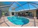 Spacious screened pool area with metal roof offers a luxurious outdoor living space and water view at 26098 Constantine Rd, Punta Gorda, FL 33983