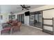 Covered patio features lounge seating, TV, ceiling fans, and views of pool and lake at 26098 Constantine Rd, Punta Gorda, FL 33983