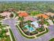 An aerial view of homes in a community with a pool at 28120 Pablo Picasso Dr, Englewood, FL 34223