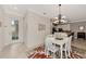 Dining area adjacent to the kitchen with white table and chairs at 28120 Pablo Picasso Dr, Englewood, FL 34223