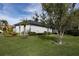 Single-story home with white exterior and palm trees at 3030 Rivershore Ln, Port Charlotte, FL 33953