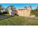 Orange single-wide mobile home with a well-maintained lawn at 3150 Tenth St, Englewood, FL 34224