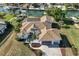 Stunning aerial view of a waterfront home with a pool, a dock, and lush landscaping at 385 Pelican Bnd, Placida, FL 33946