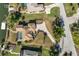An aerial perspective of the home showcasing a pool, waterfront access, and lush greenery at 385 Pelican Bnd, Placida, FL 33946