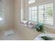 Bathroom with tiled shower and a window with plantation shutters at 385 Pelican Bnd, Placida, FL 33946