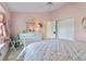Pink bedroom featuring white furniture, a window seat, and access to a closet at 385 Pelican Bnd, Placida, FL 33946