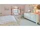 Pink bedroom with white furniture, window seat, and decorative accents at 385 Pelican Bnd, Placida, FL 33946
