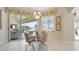 Breakfast nook with glass-top table, sliding glass doors to the pool, and water view at 385 Pelican Bnd, Placida, FL 33946