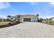 Paved driveway leading to a two-car garage with a screened enclosure at 385 Pelican Bnd, Placida, FL 33946
