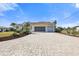 Front view of the home's driveway, garage, and landscaping at 385 Pelican Bnd, Placida, FL 33946