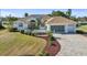 Lovely home with a paver driveway, landscaped yard, and attached garage at 385 Pelican Bnd, Placida, FL 33946