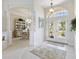 Welcoming foyer with double doors, tile floor, and arched entryway to the dining area at 385 Pelican Bnd, Placida, FL 33946