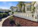 Close-up view of home's elegant entrance with white balustrade, landscaping, and pavers at 385 Pelican Bnd, Placida, FL 33946