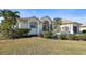 Inviting single-Gathering home with lush landscaping, palm trees, and a covered garage at 385 Pelican Bnd, Placida, FL 33946