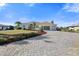 Front yard with lush landscaping and a paved driveway at 385 Pelican Bnd, Placida, FL 33946