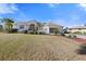 Front exterior view showcasing a well-maintained lawn, landscaping, and driveway at 385 Pelican Bnd, Placida, FL 33946