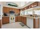 Kitchen featuring wood cabinetry, stainless steel appliances, and tile floor at 385 Pelican Bnd, Placida, FL 33946